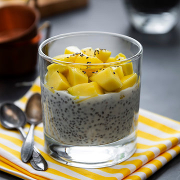 Coconut Chia seed pudding with pineapple, dark background copy space. Healthy food breakfast. Square image.