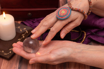 woman fortune teller holds a ball of fate in her hands, a magic ball of predictions. The concept of...