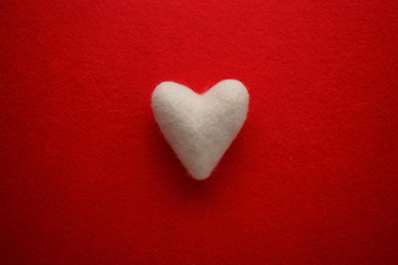 Fototapeta premium White heart on a red background. Valentine's day background.