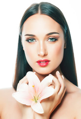 young attractive lady close up with hands on face isolated flower lily brunette spa nude makeup macro