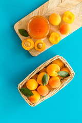 Friut background with apricot jam on blue background top view