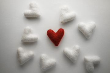 Obraz premium A red heart among many white hearts. Valentine's Day Concept 