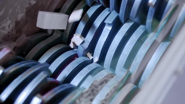 Woodworking Machine. Shredder grinds wooden boards. Woodworking industry. Fly chips and sawdust. Destruction of logs.