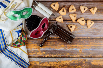 Traditional jewish carnival holiday Purim celebration and hamantaschen cookies, noisemaker and...