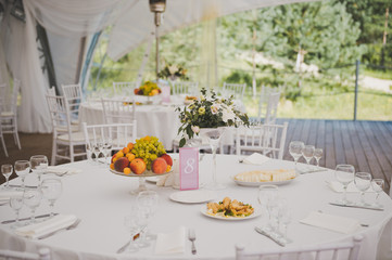Round dining table with laid out for visitors appliances 2382.