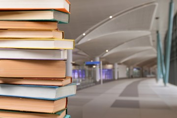 Old antique books stacked on mall background.