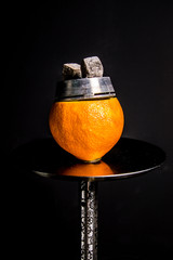 grapefruit bowl on a hookah. Lotus Kaluga with glowing coals. tobacco clogged the citrus.