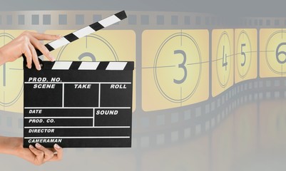 Hands holding film clapper board