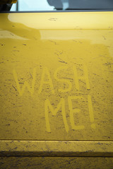 Write the words inscription text " wash me " on the very dirty surface of the car. Concept car wash.