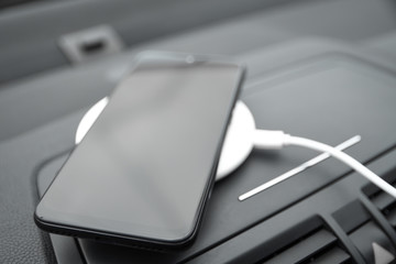  Mobile phone, smartphone charge battery ,wireless charging in the car plug close up
