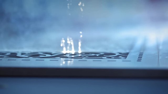 Laser cutting on wood. A large technological machine burns through a wooden board. New technologies in woodworking. Industrial laser is cutting a pattern on a plywood sheet and moving slowly