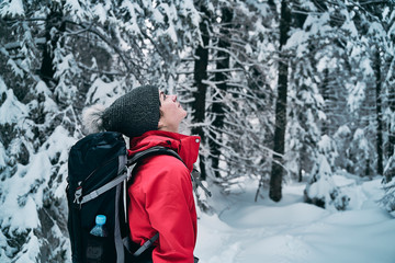 female hiker admiring beautiful snowy nature. 