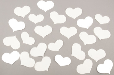 Fototapeta na wymiar White paper hearts on grey background