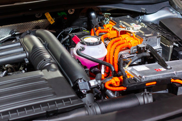 Under the hood of a hybrid or electric car. Detail of electric car engine.