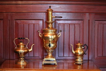 Fototapeta na wymiar Two old copper teapots and a samovar in the Durbes manor on the outskirts of the Latvian city of Tukums in May 2019