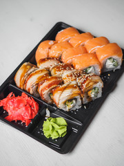 Japanese food sushi roll with raw fish and rice. delivery plastic boxes