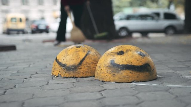 Happy faces spray painted on sidewalk blockades in Odessa Ukraine City Center