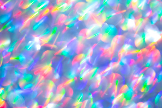 Blurred background with holographic sparkles and lights.