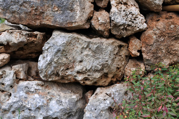 stone wall of an ancient temple. background with beige weathered stones.