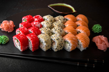 Sushi set of Philadelphia, California with fresh ingredients on black background. Sushi menu. Japanese food. 