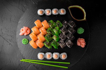 Sushi set of Philadelphia, California with fresh ingredients on black background. Sushi menu. Japanese food. 