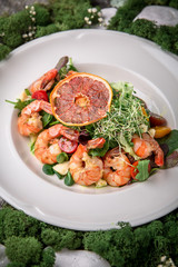 Salad of shrimp, green mix: arugula, valerian, lattuk, beet leaves, cherry tomatoes and delicious sauce. Banquet festive dishes. Fine dining restaurant menu. Eco life style healthy eating 