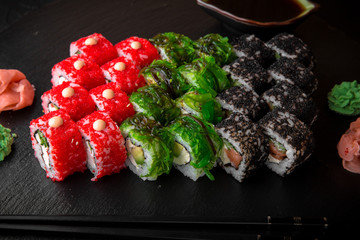 Sushi set of Philadelphia, California with fresh ingredients on black background. Sushi menu. Japanese food. 