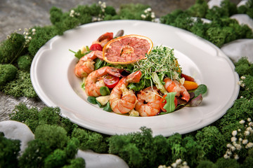 Salad of shrimp, green mix: arugula, valerian, lattuk, beet leaves, cherry tomatoes and delicious sauce. Banquet festive dishes. Fine dining restaurant menu. Eco life style healthy eating 