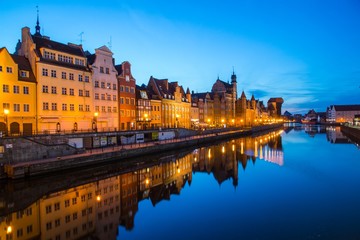 Fototapeta na wymiar Gdansk at night with reflection in Motlawa river, Poland