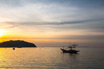 Naklejka na ściany i meble Fishermen boat at sunset near Koh Phangan island, Thailand