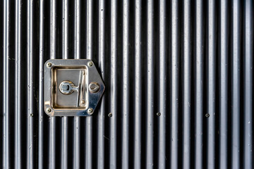 Grey corrugated steel door with stainless steel handle