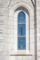 Fototapeta na wymiar narrow church window on the white wall