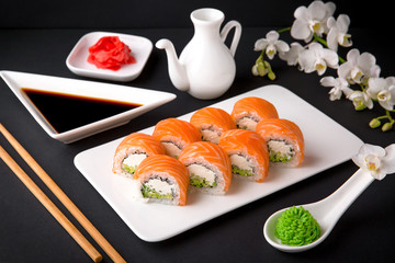 Philadelphia Sushi Roll made of Fresh Salmon, Avocado and Cream Cheese inside. Traditional Japanese cuisine. Asian food