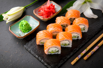 Philadelphia Sushi Roll made of Fresh Salmon, Avocado and Cream Cheese inside. Traditional Japanese cuisine. Asian food