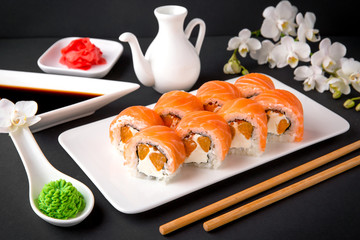 Philadelphia Sushi Roll made of Fresh Salmon, mandarin slices and Cream Cheese inside. Traditional Japanese cuisine. Asian food