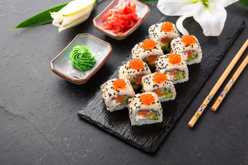 Sushi roll sushi  with fresh juicy salmon, Philadelphia cheese, sesame, red caviar salmon roe, avocado. Sushi menu. Japanese food. Asian food