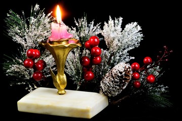 Obraz na płótnie Canvas Bright vintage Christmas candle, a symbol of faith, hope, love and elegant winter snow-covered spruce branch, a traditional decoration of the new year holiday, fun, recreation.