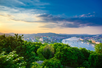 A view along the Danube River of Budapest, Hungary from Gellert Hill at sunset.