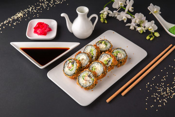 Hot fried Sushi Roll with salmon, tuna, avocado and cheese. Sushi menu. Japanese food.