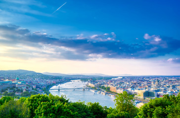 A view along the Danube River of Budapest, Hungary from Gellert Hill at sunset.