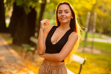 Bright photos of a brunette in nature.The autumn is warm and beautiful girl