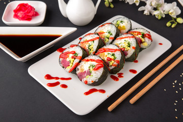 Hot fried Sushi Roll with salmon, tuna, avocado and cheese. Sushi menu. Japanese food.