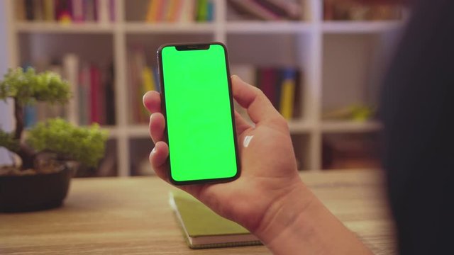 Close up hands man hold phone with vertical green screen use touch digital smartphone home communication technology business internet chroma social media click background slow motion