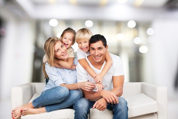 Obraz na płótnie Canvas Beautiful smiling Lovely family siting on sofa
