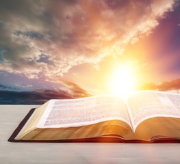 Holy Bible book on a sunset background