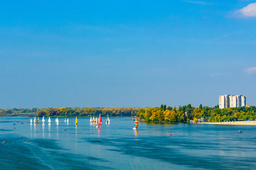 Many yachts at the river Dnieper on autumn in Kremenchug, Ukraine. Sailing regatta
