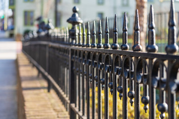 Black Iron Fence along a Small Town Main Street sidewalk.
