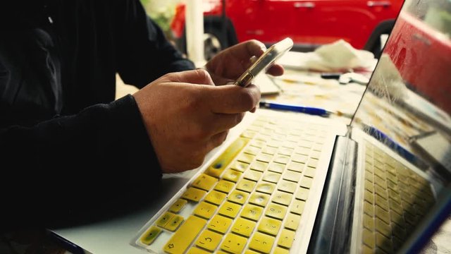 A guy working in his computer in the countryside, mobile offices, remote working