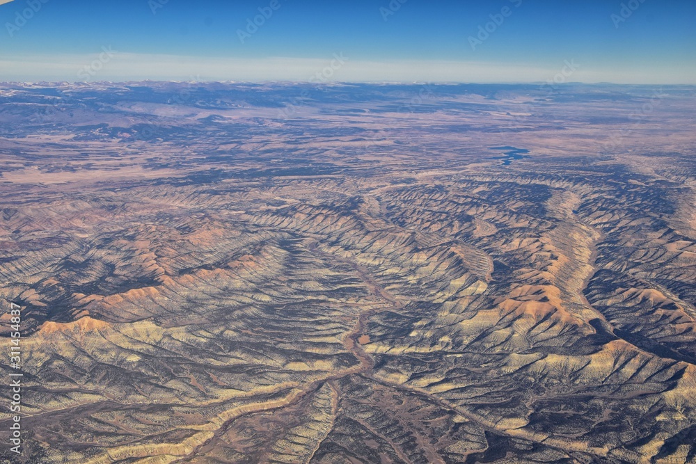 Wall mural Colorado Rocky Mountains Aerial panoramic views from airplane of abstract Landscapes, peaks, canyons and rural cities in southwest Colorado and Utah. United States of America. USA. - Wall murals