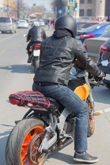 Naklejka premium motorcyclists on city street in the afternoon
